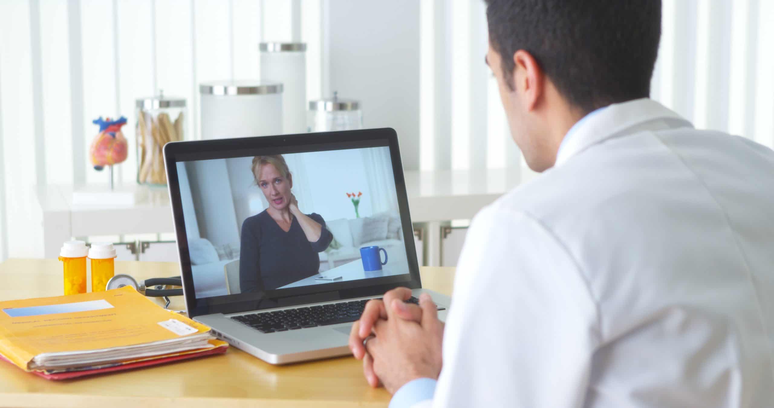 Un docteur qui fait un appel vidéo à une femme